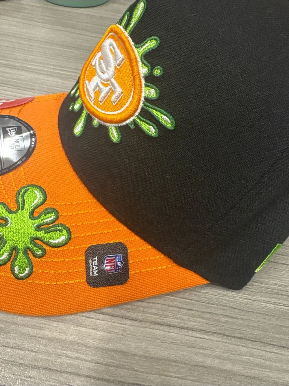 New Era Kids Orange and Black Baseball Cap with Green Embroidery
